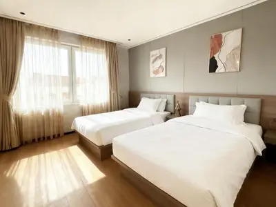 a bedroom with two beds and a window at Sky Vista Hotel in Ledine
