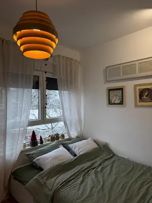 a bedroom with two beds and a large window at DUMA Apartmani Arandjelovac in Arandjelovac