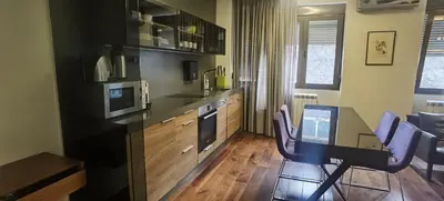 a kitchen with a table and a dining room at Calm & Central Two Bedroom Apartment in Belgrade