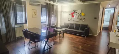a living room with a table and a couch at Calm & Central Two Bedroom Apartment in Belgrade