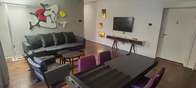 a living room with a couch and a flat screen tv at Calm & Central Two Bedroom Apartment in Belgrade
