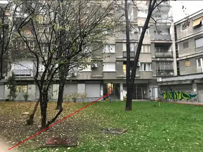 a group of trees in front of a building at Calm & Central Two Bedroom Apartment in Belgrade