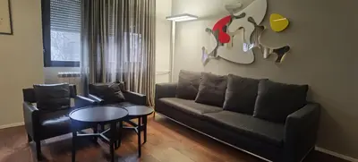 a living room with a couch and a table at Calm & Central Two Bedroom Apartment in Belgrade