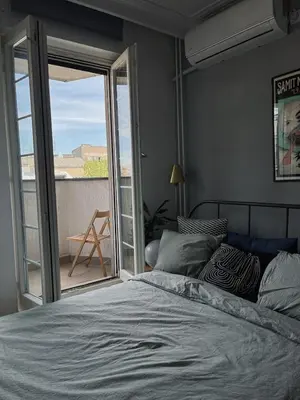 a bedroom with a bed and a sliding glass door at Cozy Apart Central Oasis in Belgrade