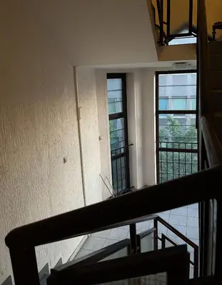 an empty room with two windows and a staircase at Cozy Apart Central Oasis in Belgrade