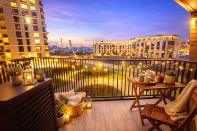 a balcony with a table and a view of a city at Metropoliten Apartments Belgrade Waterfront in Belgrade