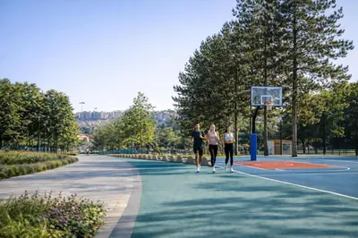 three women playing basketball on a basketball court at Metropoliten Apartments Belgrade Waterfront in Belgrade