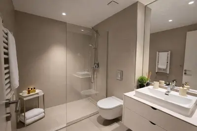 a bathroom with a sink and a toilet and a shower at Metropoliten Apartments Belgrade Waterfront in Belgrade