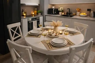 a white dining room table with chairs and wine glasses at Metropoliten Apartments Belgrade Waterfront in Belgrade