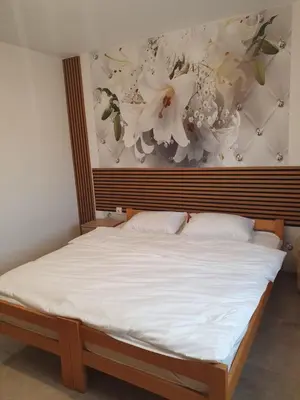a bedroom with a bed with a flower mural on the wall at Cute 3-bedroom apartment at nice place in Pančevo in Pančevo