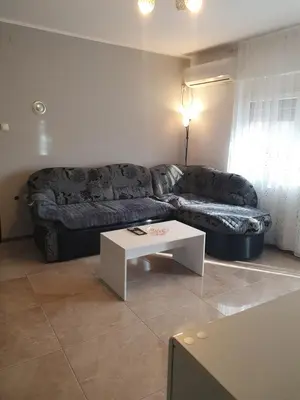 a living room with a couch and a table at Cute 3-bedroom apartment at nice place in Pančevo in Pančevo