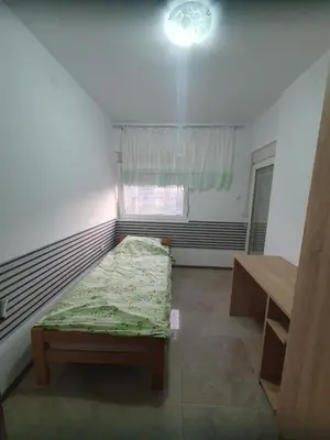 a small room with a bed and a window at Cute 3-bedroom apartment at nice place in Pančevo in Pančevo