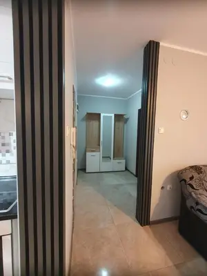 a hallway leading to a room with a bed and a kitchen at Cute 3-bedroom apartment at nice place in Pančevo in Pančevo