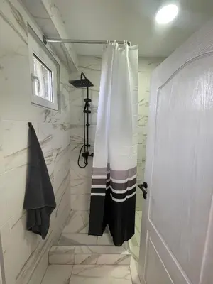 a bathroom with a shower with a shower curtain at Stan na dan Pecinci in Pećinci