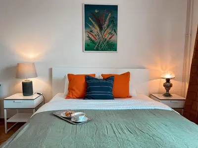 a bedroom with a bed with a tray of food on it at Ollio - Art of Dorcol in Belgrade