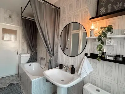 a bathroom with a sink and a mirror at Ollio - Art of Dorcol in Belgrade