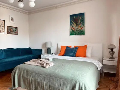 a bedroom with a bed and a blue couch at Ollio - Art of Dorcol in Belgrade