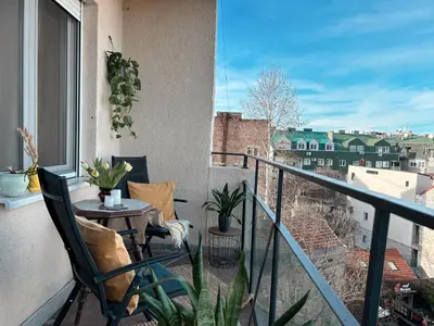 a balcony with a table and chairs on a balcony at Ollio - Art of Dorcol in Belgrade