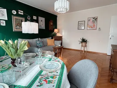 a living room with a table and a couch at Ollio - Art of Dorcol in Belgrade