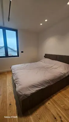 a large bed in a room with a large window at Zemun Golax Apartments in Belgrade