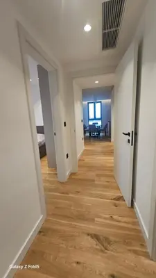 a hallway of an apartment with wooden floors at Zemun Golax Apartments in Belgrade