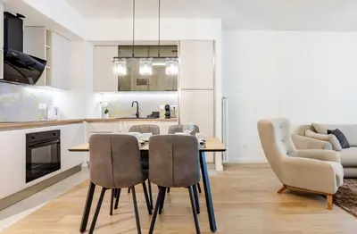 a kitchen and dining room with a table and chairs at Belgrade Waterfront - Beograd na Vodi - Sensa in Belgrade