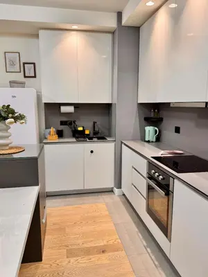 a kitchen with white cabinets and a stove top oven at BW Luna - stay inspired! in Belgrade