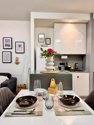 a kitchen with a table with plates and wine glasses at BW Luna - stay inspired! in Belgrade