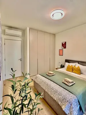 a bedroom with a bed and a plant at BW Luna - stay inspired! in Belgrade