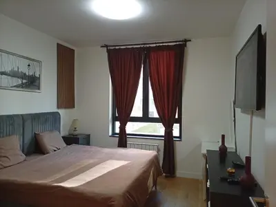 a bedroom with a bed and a large window at 2 Beograd na Vodi Belgrade Waterfront posaljite poruku radi info o nacinu ulaska i preuzimanje kljuca in Belgrade