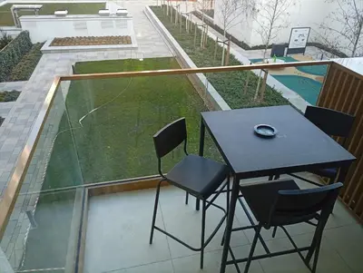 a table and chairs on a balcony with a tennis court at 2 Beograd na Vodi Belgrade Waterfront posaljite poruku radi info o nacinu ulaska i preuzimanje kljuca in Belgrade