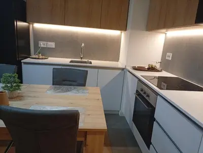 a kitchen with a wooden table and a sink at 2 Beograd na Vodi Belgrade Waterfront posaljite poruku radi info o nacinu ulaska i preuzimanje kljuca in Belgrade