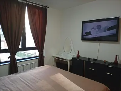 a bedroom with a bed and a tv on the wall at 2 Beograd na Vodi Belgrade Waterfront posaljite poruku radi info o nacinu ulaska i preuzimanje kljuca in Belgrade