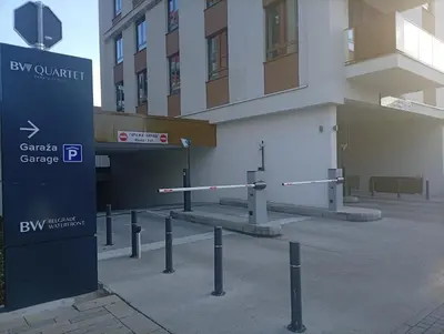 a parking lot with barriers in front of a building at 2 Beograd na Vodi Belgrade Waterfront posaljite poruku radi info o nacinu ulaska i preuzimanje kljuca in Belgrade