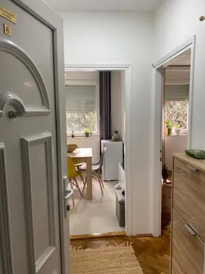 a door leading into a dining room with a table at Apartman Titi in Smederevo