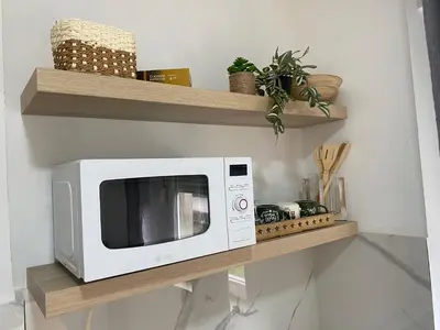 a microwave sitting on a shelf in a kitchen at Apartman Titi in Smederevo