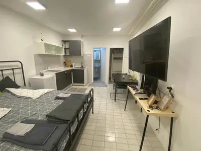a living room with two beds and a flat screen tv at Dona1102 in Žarkovo