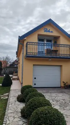 a house with a white garage with a balcony at Apartman Pavle Mladenovac in Mladenovac