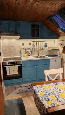 a kitchen with blue cabinets and a sink and a stove at Apartman Pavle Mladenovac in Mladenovac