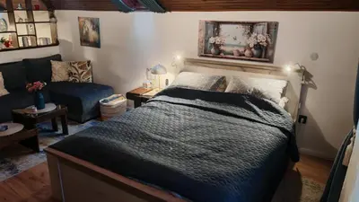 a bedroom with a bed and a couch at Apartman Pavle Mladenovac in Mladenovac
