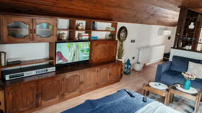 a living room with a tv and a blue couch at Apartman Pavle Mladenovac in Mladenovac