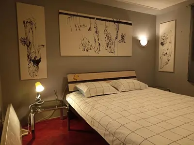 a bedroom with a large white bed with two pillows at Paws & Pines Hideaway in Belgrade