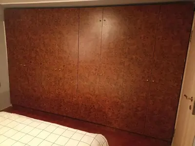 a bedroom with a brown wall and a bed at Paws & Pines Hideaway in Belgrade