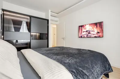 a bedroom with a large bed in a room at Belgrade Waterfront - Beograd na vodi - Beograd in Belgrade
