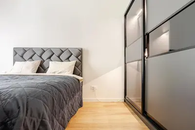 a bedroom with a bed and a glass wall at Belgrade Waterfront - Beograd na vodi - Beograd in Belgrade