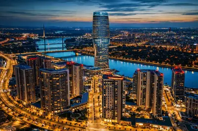 a city skyline at night with a tall skyscraper at Modern Premium Studio - Belgrade Waterfront - Verde in Belgrade