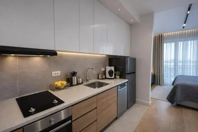a kitchen with a sink and a bed in a room at Modern Premium Studio - Belgrade Waterfront - Verde in Belgrade