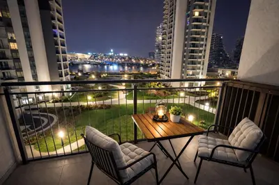 a balcony with a table and two chairs on a balcony at Modern Premium Studio - Belgrade Waterfront - Verde in Belgrade