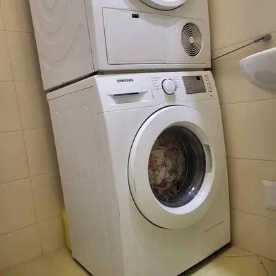 a washing machine in a bathroom with a sink at MMM Suite in Belgrade