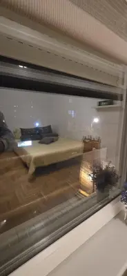 a reflection of a bed in a window at City Stay Apartments in Belgrade